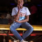 Mvhayv Barker holds back laughter as her friends and family skate around her.