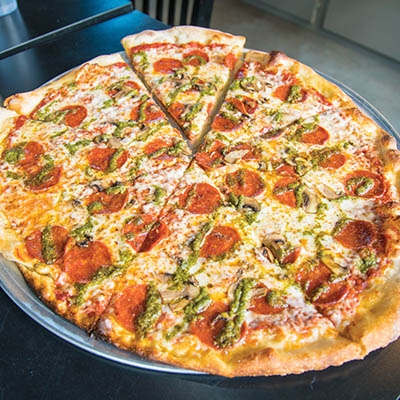 A signature pie from Bobby O’s featuring pepperoni, mushroom, and pesto.