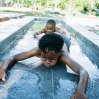 Timothy and Maquan play at the 41st Street River Parks plaza