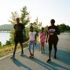 Petra, Glory, Joy, and Elisa walk on the River Parks East Trail near Helmerich Park