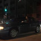 A man looks at protesters blocking traffic on Denver Avenue.