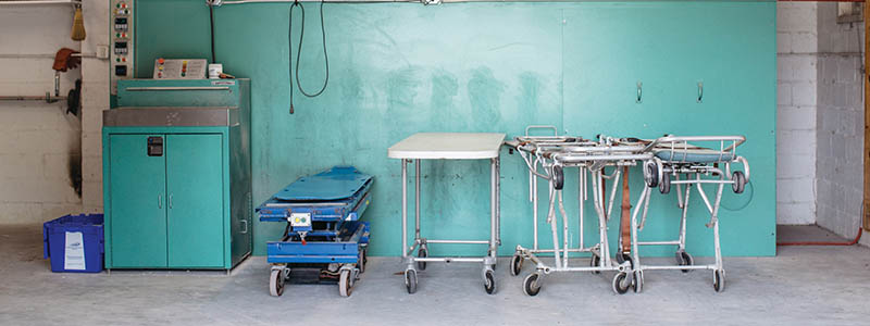 The cremator and its black flume, with prep tables and stretchers