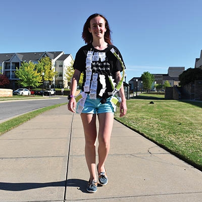 Lauren Haygood, a graduate student at TU, wears the names of programs cut by the university’s “True Commitment” plan. 