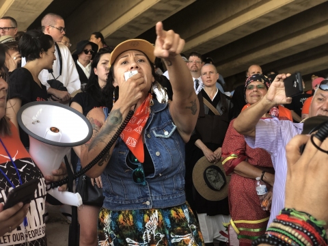 Ashley Nicole McCray, environmental scholar and 2018 candidate for Oklahoma Corporation Commissioner, speaks to a crowd of protestors beneath a highway overpass outside of the Fort Sill Army installation in southwestern Oklahoma. Photo by Jessica Vazquez.