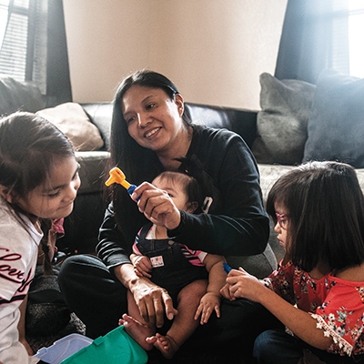 Leslie Deere plays with her grandchildren at her daughter’s home in Seminole. Deere was a participant in the Muscogee (Creek) Nation’s Reintegration Program and recently enrolled in a course to become a truck driver.