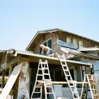 A man works on a roof in Brady Heights