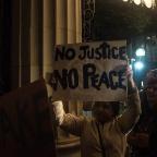 Protesters gather outside the entrance to the Mayo Hotel in downtown Tulsa calling for the staff to “Bring out the Murderer” and shouting “No Justice, No peace” along with “Hands up, Don't shoot.”