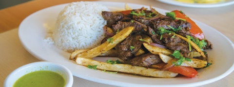 Lomo Saltado at Pachac Peruvian Food is made from stir-fried beef, onions, sliced tomatoes, French fries, and cilantro over steamed rice