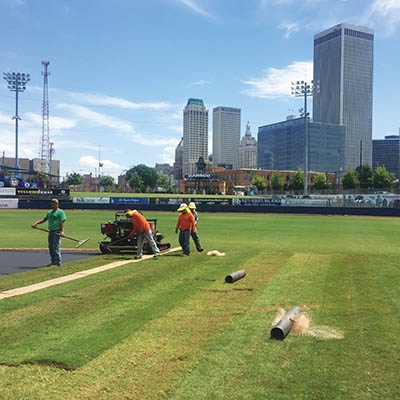 Grounds crew adds sod to convert ONEOK baseball field into a soccer pitch