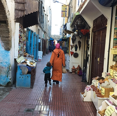 A woman holds a child’s hand in the medina, or old town, in Essaouira, Morocco