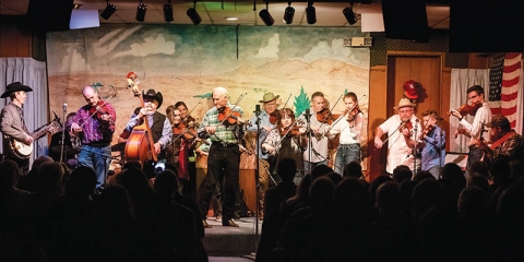 Byron Berline (center) performs during the final community jam session on the second floor of his iconic Double Stop Fiddle Shop in Guthrie, which burned in a fire on Feb. 23.