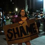 Protesters gather outside the entrance to the Mayo Hotel in downtown Tulsa calling for the staff to “Bring out the Murderer” and shouting “No Justice, No peace” along with “Hands up, Don't shoot.”