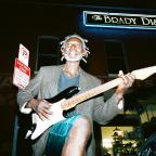 Charles Reed plays guitar next to The Tavern on East M.B. Brady Street.