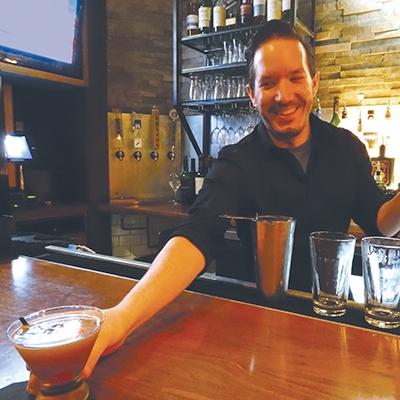 Luke Constable serving Manhattans at Palace Café