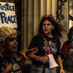 Protesters gather outside the entrance to the Mayo Hotel in downtown Tulsa calling for the staff to “Bring out the Murderer” and shouting “No Justice, No peace” along with “Hands up, Don't shoot.”