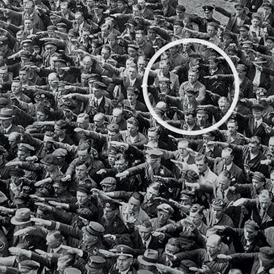 Workers at the Blohm + Voss shipyard salute Adolf Hitler in June 1936. All except one. 