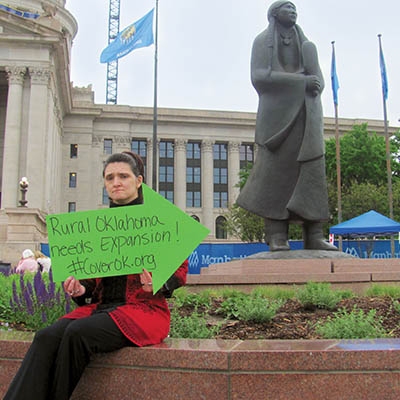 Michele Eccleson, a cancer survivor suffering from scoliosis and a heart condition, rallies to expand 
coverage at the Oklahoma State Capitol on April 24.