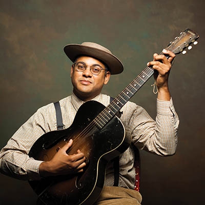 Grammy-winning folk musician Dom Flemons with his trusty guitar.